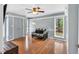 Inviting bedroom with three windows, hardwood floors, and neutral paint color at 520 Log Barn Rd, Pittsboro, NC 27312