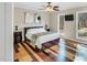 Bedroom with accent wall paneling, hardwood floors, and ample natural light at 520 Log Barn Rd, Pittsboro, NC 27312