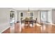 Traditional dining room with hardwood floors and natural light from windows, leading to the living room at 520 Log Barn Rd, Pittsboro, NC 27312