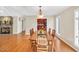 Cozy dining room with connecting access to kitchen and living room with stone fireplace at 520 Log Barn Rd, Pittsboro, NC 27312
