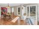 Sunlit dining room features wood floors, adjacent kitchen and mud room with built-in hall tree at 520 Log Barn Rd, Pittsboro, NC 27312