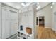 Inviting entryway with storage bench, coat hooks, skylights, and wood floors at 520 Log Barn Rd, Pittsboro, NC 27312