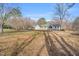 Exterior view of the home with expansive lawn and mature trees at 520 Log Barn Rd, Pittsboro, NC 27312