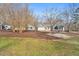 Charming home featuring a sprawling yard with mature trees and landscaping at 520 Log Barn Rd, Pittsboro, NC 27312