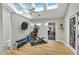 Bright home gym with exercise bike and a view to another room at 520 Log Barn Rd, Pittsboro, NC 27312