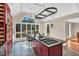 Bright gourmet kitchen featuring custom island with cooktop, seating, granite countertops, and plenty of sunshine at 520 Log Barn Rd, Pittsboro, NC 27312