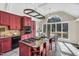 Spacious kitchen with custom island featuring cooktop, seating, granite countertops, and abundant natural light at 520 Log Barn Rd, Pittsboro, NC 27312