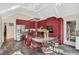 Bright red kitchen with an island eating area, tile floors, and stainless steel appliances at 520 Log Barn Rd, Pittsboro, NC 27312