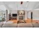 Bright living room with hardwood floors, a brick fireplace, and a beamed, vaulted ceiling at 520 Log Barn Rd, Pittsboro, NC 27312