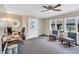 Neutral-toned office with two chairs, a ceiling fan, and a wooden desk at 520 Log Barn Rd, Pittsboro, NC 27312