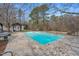 Inviting pool area surrounded by a stone patio and lush greenery, perfect for outdoor enjoyment at 520 Log Barn Rd, Pittsboro, NC 27312