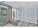 Stylish walk-in shower featuring decorative tiling, a glass partition, and built-in shower bench at 520 Log Barn Rd, Pittsboro, NC 27312