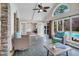 Enclosed sunroom with flagstone floor, wicker seating, and an open view into a backyard swimming pool at 520 Log Barn Rd, Pittsboro, NC 27312