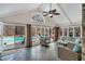 Bright sunroom with slate tile flooring, a ceiling fan, and views of the in-ground pool at 520 Log Barn Rd, Pittsboro, NC 27312