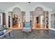 Bright sunroom featuring stone arches, flagstone floors, and views into other living spaces at 520 Log Barn Rd, Pittsboro, NC 27312