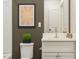 Neutral bathroom featuring a modern sink and vanity, a unique artwork, and modern fixtures at 5322 River Reach Dr, Raleigh, NC 27616