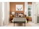 Bright bedroom with natural light, featuring modern lamps, pillows, and a large window at 5322 River Reach Dr, Raleigh, NC 27616