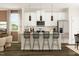 Open-concept kitchen featuring white cabinets, a center island, and bar stool seating at 5322 River Reach Dr, Raleigh, NC 27616
