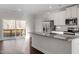 Bright kitchen featuring a breakfast bar, granite countertops, and sliding glass doors at 5322 River Reach Dr, Raleigh, NC 27616
