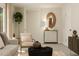 Cozy living room featuring neutral tones, elegant furnishings, and a decorative oval mirror at 5322 River Reach Dr, Raleigh, NC 27616