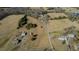 An aerial perspective showcasing the vast property, highlighting its expansive fields and multiple structures at 5436 New Oak Trl, Burlington, NC 27217