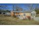 View of backyard with concrete patio and yellow siding, perfect for outdoor entertaining at 5436 New Oak Trl, Burlington, NC 27217