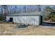 Exterior view of the barn with large bay doors and white metal siding at 5436 New Oak Trl, Burlington, NC 27217