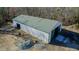 Overhead angle of the metal building with gravel parking and green roof at 5436 New Oak Trl, Burlington, NC 27217