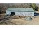 Overhead angle of the metal building with green roof and open bay doors at 5436 New Oak Trl, Burlington, NC 27217