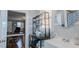 A bathroom includes a shelving unit and a sink and vanity, all illuminated by natural light from a window at 5436 New Oak Trl, Burlington, NC 27217
