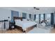 Bright bedroom with hardwood floors, accent brick, and blue curtains, with a full-sized drumset at 5436 New Oak Trl, Burlington, NC 27217