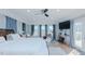 Bright bedroom with hardwood floors, exposed brick, blue curtains, patio access, and a drumset at 5436 New Oak Trl, Burlington, NC 27217