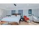 Spacious bedroom with exposed brick accent wall, wood floors, and natural light from several windows at 5436 New Oak Trl, Burlington, NC 27217