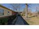 Brick home with a sidewalk leading to the front entrance, enhanced by mature trees and garden beds at 5436 New Oak Trl, Burlington, NC 27217