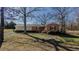 Charming single-story home with a brick facade and a well-maintained lawn surrounded by mature trees at 5436 New Oak Trl, Burlington, NC 27217