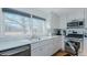 Bright kitchen featuring white cabinets, stainless appliances, marble counters, and views of the outdoors at 5436 New Oak Trl, Burlington, NC 27217
