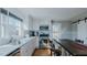 Sun-filled kitchen featuring stainless steel appliances, marble counters, and eat-in breakfast bar at 5436 New Oak Trl, Burlington, NC 27217