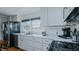 Well-appointed kitchen featuring stainless steel appliances, white marble countertops, and sleek cabinetry at 5436 New Oak Trl, Burlington, NC 27217