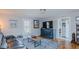 A comfortable living room featuring hardwood floors, stylish furniture, and a view through an interior doorway at 5436 New Oak Trl, Burlington, NC 27217