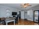 An office boasts a ceiling fan, wooden floors, a desk, and a view into a hallway for an open feel at 5436 New Oak Trl, Burlington, NC 27217