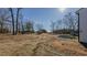 Expansive property view with open land, mature trees, and outbuildings at 5436 New Oak Trl, Burlington, NC 27217