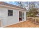View of the back deck with white siding and a door to the backyard at 7 Harrigan Ct, Durham, NC 27705