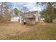 Exterior view of backyard with a wood deck and stairs leading to the ground level at 7 Harrigan Ct, Durham, NC 27705