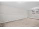 Spacious basement with carpeting, neutral walls, and a window for natural light at 7 Harrigan Ct, Durham, NC 27705