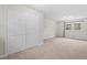 Bedroom featuring neutral walls and carpeting with large closet and window for natural light at 7 Harrigan Ct, Durham, NC 27705
