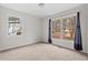 Bright bedroom featuring two large windows letting in natural light and neutral carpeting at 7 Harrigan Ct, Durham, NC 27705
