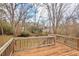 Wooden deck overlooking the backyard area with many trees at 7 Harrigan Ct, Durham, NC 27705