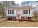 Charming two-story home with brick accents, a well-maintained lawn, and colorful shutters, offering classic curb appeal at 7 Harrigan Ct, Durham, NC 27705