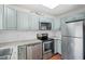 Well-appointed kitchen with stainless steel appliances, granite countertops, and ample cabinet space at 7 Harrigan Ct, Durham, NC 27705