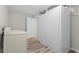 Functional laundry room with washer, dryer, and ample storage space behind closed doors at 7 Harrigan Ct, Durham, NC 27705